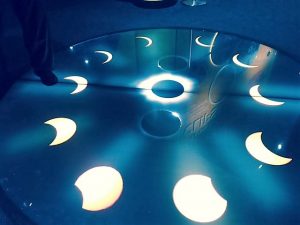 A lit floor model in the Adler exhibit shows the moon's moves across the sun blocking it from viewers on the way to a total solar eclipse. Photo by Jodie Jacobs