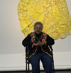 Howardene Pindell sits in front of Nautilus, (2014-15, mixed media on canvas from the Jacqueline Bradley and Clarence Otis Collection. Photos by Jodie Jacobs