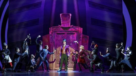 Noah Weisberg as Willy Wonka and company in Charlie and the Chocolate Factory. (Photo by Joan Marcus)