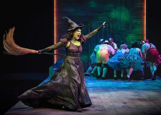 The Wicked Witch of the West (Hollis Resnick) frightens the Munchkins. (Photo by Liz Lauren)