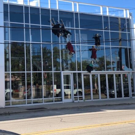 Ghostly figures climb a distillery wall of glass downtown Highwood on Sheridan Road during the Great Highwood Pumpkin festival. (J Jacobs photo)